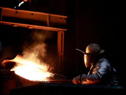 A worker manipulates a cask of molten iron during cookware production at the Lodge Manufacturing Co. factory in South Pittsburg, Tennessee, U.S., on Monday, March 7, 2022. Production at U.S. factories rose modestly in January, suggesting manufacturers are gradually working through pandemic-related shortages of materials and labor that hobbled output …