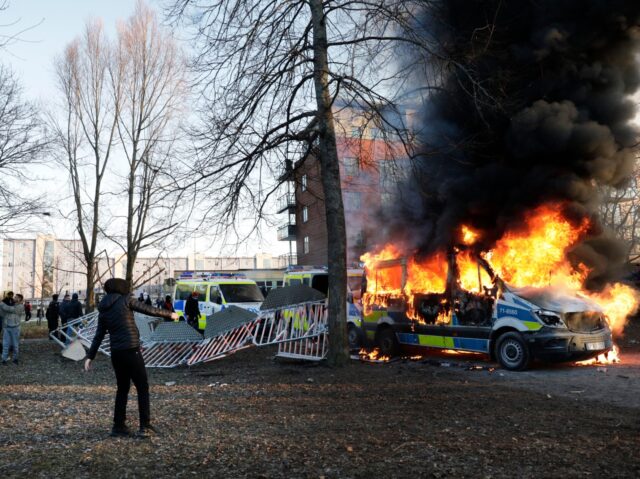 Police vans are on fire as counter-protesters react during a counter-protest in the park S