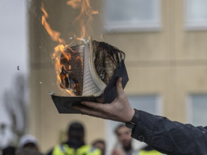 STOCKHOLM, SWEDEN - MAY 14: Rasmus Paludan burns a Koran during an election meeting in Husby on May 14, 2022 in Stockholm, Sweden. Far-right Danis-Swedish politican Rasmus Paludan, a controversial figure in Sweden, stages Koran burnings in Muslim neighborhoods as part of his political campaign. (Photo by Jonas Gratzer/Getty Images)