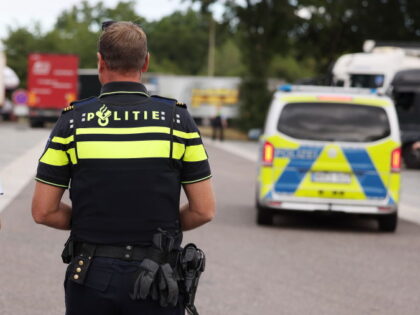 16 July 2022, North Rhine-Westphalia, Ratingen: A female police officer and a Dutch police officer walk across the Hösel service area on the A3 autobahn. The police are using the halfway point of the summer vacations as an opportunity for nationwide traffic checks. Photo: David Young/dpa (Photo by David Young/picture …