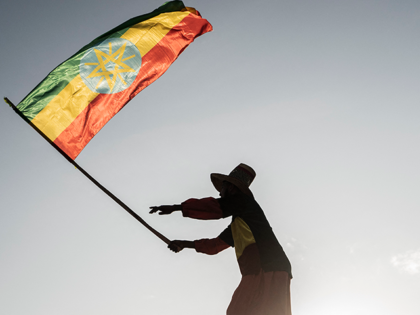 A man waves an Ethiopian flag as he join others gathering in Addis Ababa, Ethiopia, on Oct