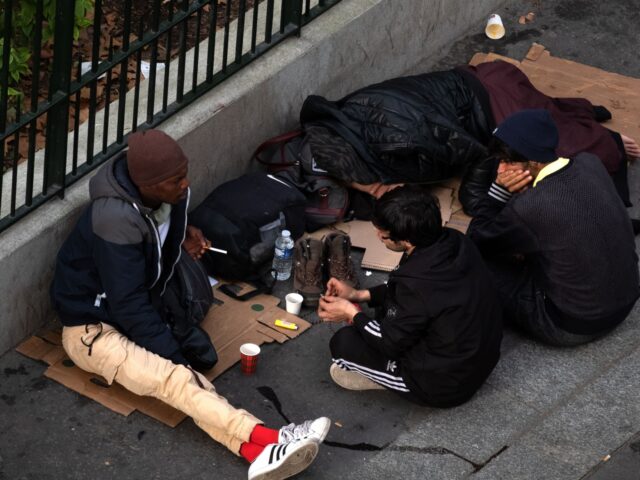 Migrants settle on a sidewalk in Paris on October 29, 2022. (Photo by JOEL SAGET / AFP) (Photo by JOEL SAGET/AFP via Getty Images)