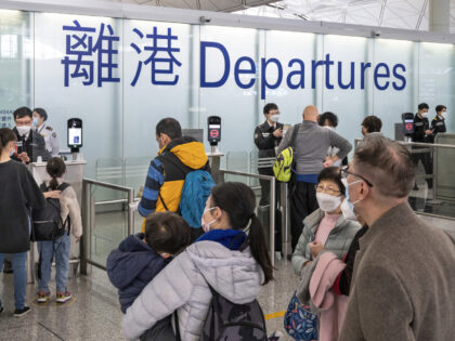 HONG KONG, CHINA - 2022/12/29: Passengers go through the departure hall as friends and family say goodbye in Hong Kong's Chek Lap Kok International Airport. Visitors to Hong Kong would no longer require to undergo the "0+3" covid (Covid-19) medical surveillance period after the government ended travel restrictions. (Photo by …