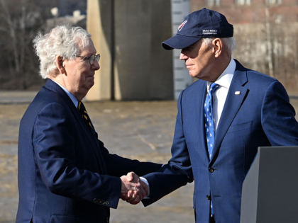 US President Joe Biden (R) shakes hands with Senate Minority Leader Mitch McConnell during an event about the bipartisan infrastructure law in front of the Clay Wade Bailey Bridge in Covington, Kentucky, on January 4, 2023. (Photo by Jim WATSON / AFP) (Photo by JIM WATSON/AFP via Getty Images)