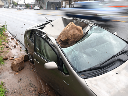 Malibu California January 10, 2023-A boulder crashed on top of a parked car along P.C.H. i