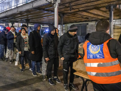 PARIS, FRANCE - JANUARY 11: Refugees get in line to receive humanitarian aid while taking shelter from the cold at the Stalingrad Subway Station in Paris, France on January 11, 2023. Most refugees who flee from civil wars, financial struggles and anti-democratic governments and come to France with a âEuropean …