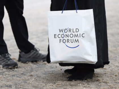 An attendee holds a branded plastic bag ahead of the World Economic Forum (WEF) in Davos, Switzerland, on Monday, Jan. 16, 2023. The annual Davos gathering of political leaders, top executives and celebrities runs from January 16 to 20. Photographer: Hollie Adams/Bloomberg via Getty Images