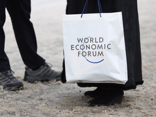 An attendee holds a branded plastic bag ahead of the World Economic Forum (WEF) in Davos,