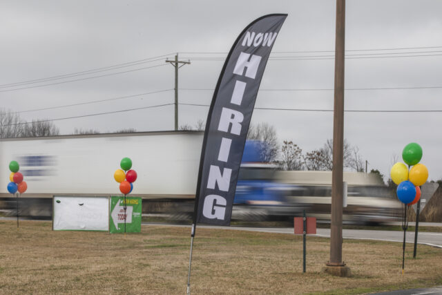 A "Now Hiring" sign during a job fair at a Schneider Electric manufacturing faci