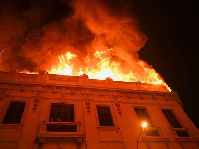 A house fire is seen during a protest against the government of President Dina Boluarte in