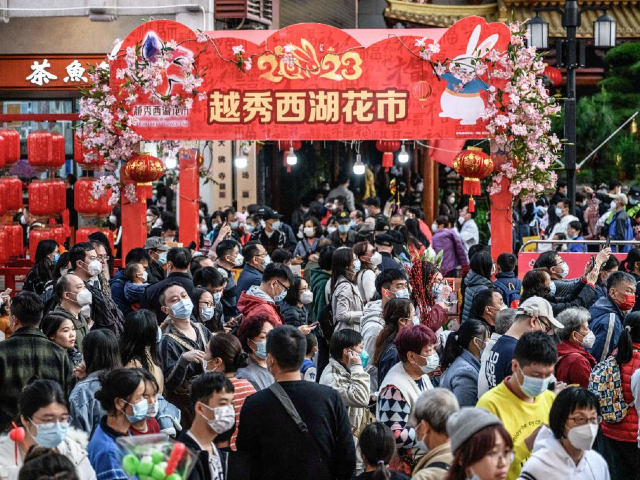 People visit a traditional Spring Festival flower market which reopens after closure due to the spread of the Covid-19 coronavirus in Guangzhou, in China's southern Guangdong province on January 20, 2023, ahead of the Lunar New Year of the Rabbit celebrations which falls on January 22. - China OUT (Photo by AFP) / China OUT (Photo by STR/AFP via Getty Images)