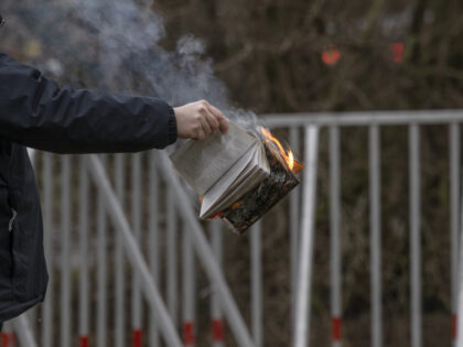 STOCKHOLM, SWEDEN - JANUARY 21: Rasmus Paludan holds a burning Koran outside of the Turkis