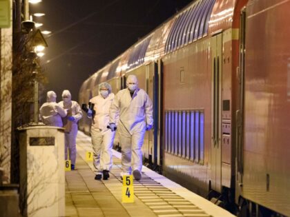 TOPSHOT - Forensic staff of the police secures and photographs evidence on the platform of the train station in Brokstedt, northern Germany, on January 25, 2023, after two people were killed and several others wounded in a knife attack on a regional train between the cities of Hamburg and Kiel. …