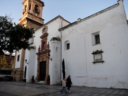 Pedestrians walk past the church where a man was killed the day before in Algeciras, southern Spain, on January 26, 2023. - Spain opened a terror probe on January 25 after a man wielding a bladed weapon stormed a church in southern Spain killing one and severely wounding a priest, …