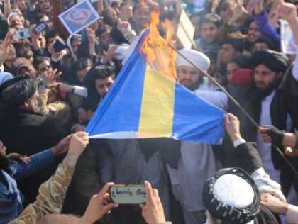 Afghans shout slogans as they burn a flag of Sweden during a protest against the burning of the Koran by Swedish-Danish far-right politician Rasmus Paludan, after Friday prayers in Jalalabad on January 27, 2023. (Photo by Shafiullah KAKAR / AFP) (Photo by SHAFIULLAH KAKAR/AFP via Getty Images)