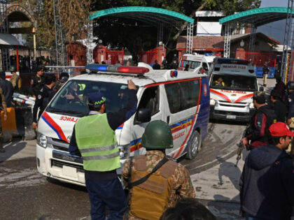 Security personnel make way for ambulances carrying injured blast victims outside the police headquarters in Peshawar on January 30, 2023. - At least 25 people were killed and 120 were injured in a mosque blast at a police headquarters in Pakistan on January 30, a local government official said. (Photo …