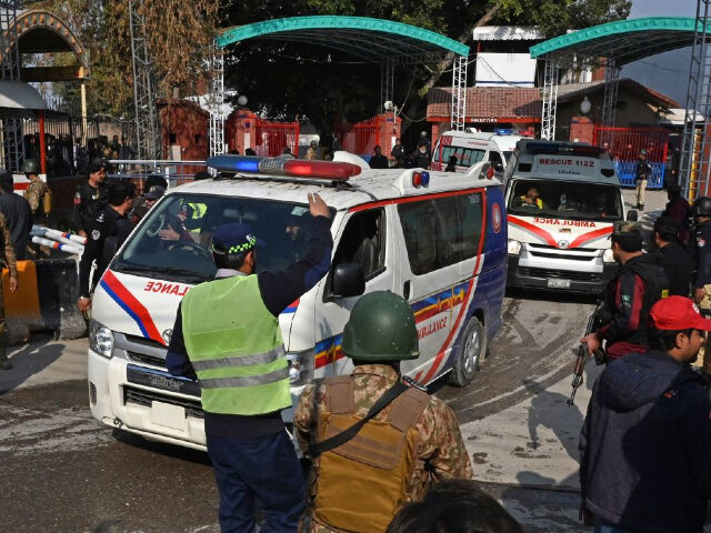 Security personnel make way for ambulances carrying injured blast victims outside the poli