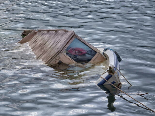 Half sunken wooden boat in Inciralti marina after verry heavy rain destroyed and sunk seve