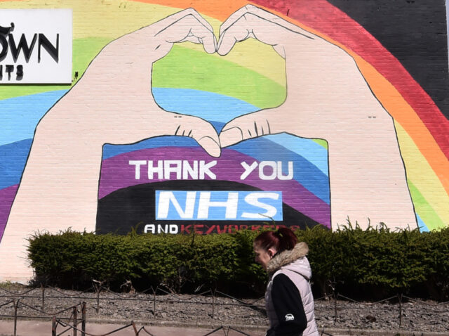 BLACKBURN, ENGLAND - APRIL 29: A lady walks past a painted mural saying "Thank you NHS and