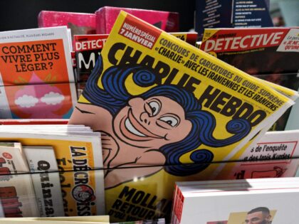 LILLE, FRANCE - JANUARY 05: The front page of "Charlie Hebdo" reading "Mollahs go back from where you come" is seen in a newsstand. The weekly had published dozens of cartoons on the same day ridiculing the highest religious and political figure in the Islamic republic. The magazine said the …