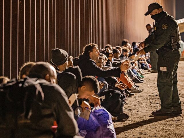 YUMA, ARIZONA - DECEMBER 30: A U.S. Border Patrol agent checks for identification of immig