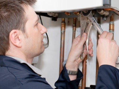 Plumber at Work on a Water Boiler