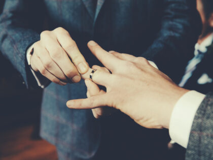 Gay Men Exchanging Rings At Wedding Ceremony