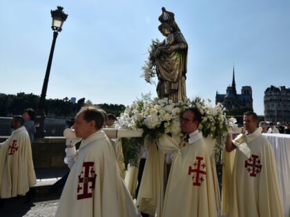 Religious people carry a statue of the Virgin Mary as they march during a Catholic process