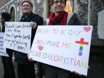 Demonstrators hold placards as they protest outside Church House, the venue of the Church of England's General Synod, in London on February 15, 2017. - Leading figures in the Church of England will on Wednesday debate same-sex marriage and homosexuality, following the publication of the the House of Bishops' report …
