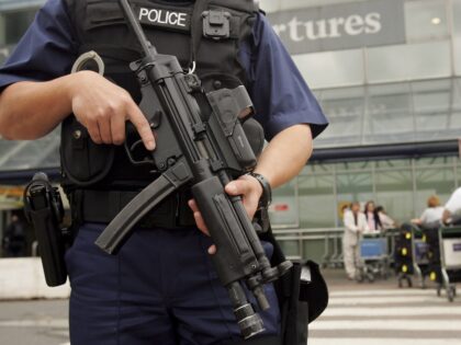 LONDON - AUGUST 11: An armed British police officer patrols outside of Heathrow Airport on August 11, 2006 in London, England. The UK security threat level is to stay at "critical" as police continue to question 24 suspects following a suspected plot to blow up several aeroplanes was uncovered. (Photo …