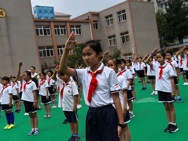 In this photograph taken on September 27, 2017, students sing the national anthem in the playground during the flag-hoisting ceremony at their school in Shanghai. Western interest in China's school system, and Shanghai in particular, has intensified after the city's pupils aced worldwide standardised tests in recent years. Teachers from …