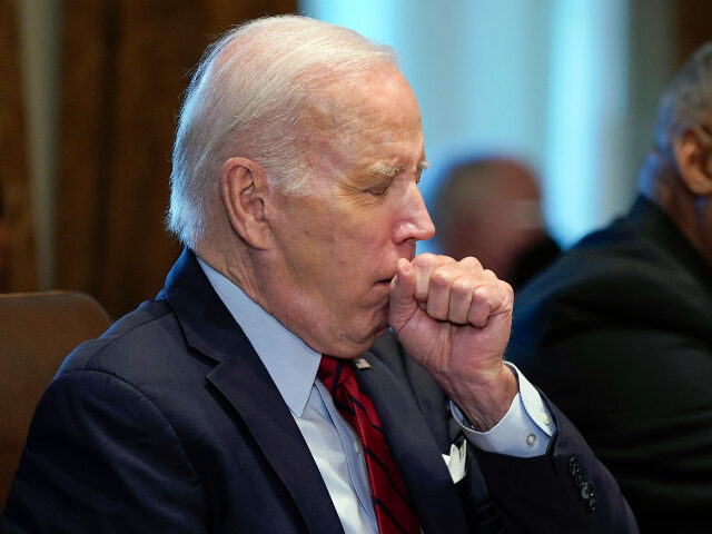 President Joe Biden coughs while speaking during a cabinet meeting at the White House, Thursday, Jan. 5, 2023, in Washington. (AP Photo/Patrick Semansky)