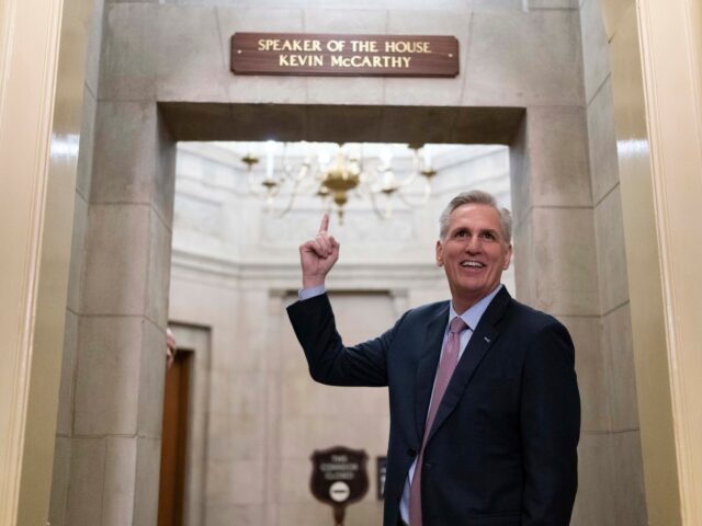 Speaker of the House Kevin McCarthy of Calif., points to the newly installed nameplate at