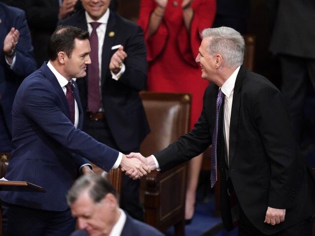Rep. Mike Gallagher, R-Wis., shakes hands with Rep. Kevin McCarthy, R-Calif., in the House