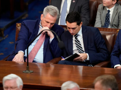 Rep. Kevin McCarthy of Calif., talks to an aide as he listens as votes are cast for next Speaker of the House during the opening day of the 118th Congress at the U.S. Capitol, Tuesday, Jan. 3, 2023, in Washington. (AP Photo/Alex Brandon)
