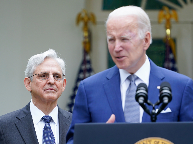 Attorney General Merrick Garland listens listens as President Joe Biden speaks in the Rose Garden of the White House in Washington, Friday, May 13, 2022, during an event to highlight state and local leaders who are investing American Rescue Plan funding. (AP Photo/Susan Walsh)
