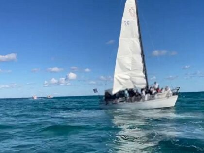 Coast Guardsmen rescue 45 Haitian migrants from an overloaded sailboat off the Florida coast. (U.S. Coast Guard Southeast Video Screenshot)