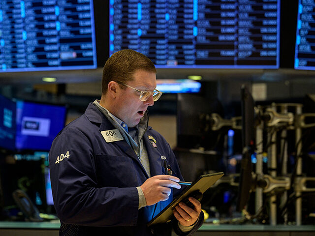 Traders work on the floor of the New York Stock Exchange during opening bell in New York C