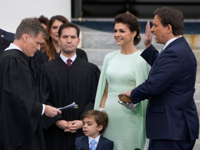 Florida Gov. Ron DeSantis, right, is sworn by Florida Supreme Court Chief Justice Carlos M