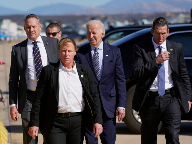 President Joe Biden walks with members of the U.S. Secret Service after greeting local mil
