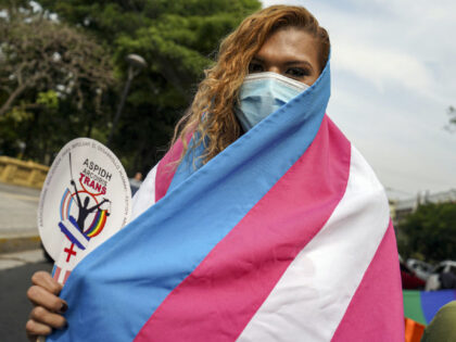 SAN SALVADOR, EL SALVADOR - 2022/05/17: A transgender woman draped in a transgender flag during a demonstration for the rights of the LGBT community, including an Identity law for transgender people. Every May 17, advocates commemorate International Day Against Homophobia, Biphobia and Transphobia to raise awareness of LGBT rights violations, …