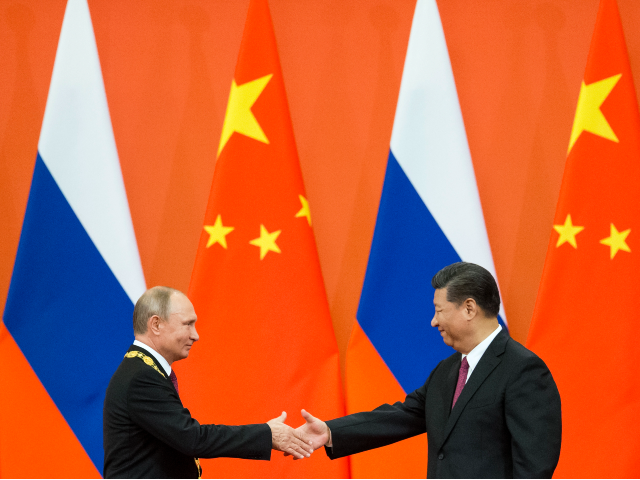 FILE - Chinese President Xi Jinping, right, and Russian President Vladimir Putin shake han