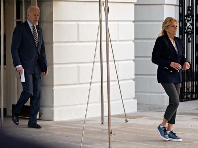 US President Joe Biden, left, and First Lady Jill Biden exit the White House before boardi