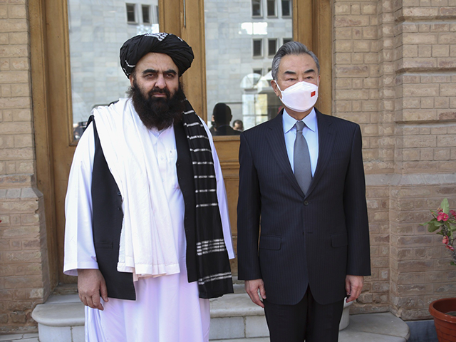 In this photo released by Xinhua News Agency, Chinese Foreign Minister Wang Yi, right, poses for photos with Amir Khan Muttaqi, acting foreign minister of the Afghan Taliban's caretaker government, in Kabul, Afghanistan on March 24, 2022. Chinese leader Xi Jinping on Thursday, March 31, 2022 issued strong backing for …