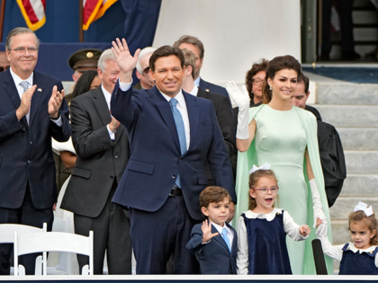 Florida Gov. Ron DeSantis, center, waves as he arrives with his wife Casey, right, and their children Mason, Madison, and Mamie before his inauguration ceremony outside the Old Capitol Tuesday, Jan. 3, 2023, in Tallahassee, Fla. Applauding at a left is former governor Jeb Bush. (AP Photo/Lynne Sladky)