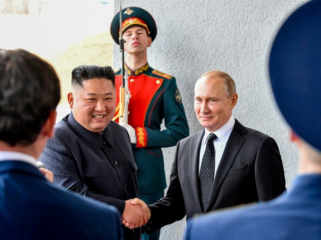 Russian President Vladimir Putin, right, and North Korea's leader Kim Jong Un pose for pho