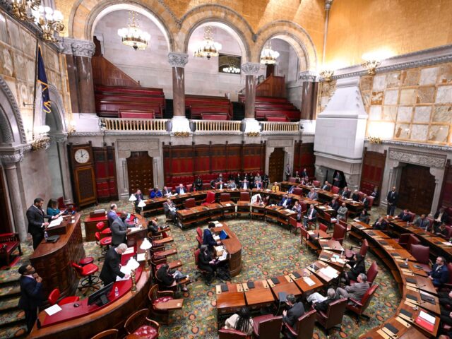Members of the New York Assembly debate legislation to approve a legislative pay raise dur