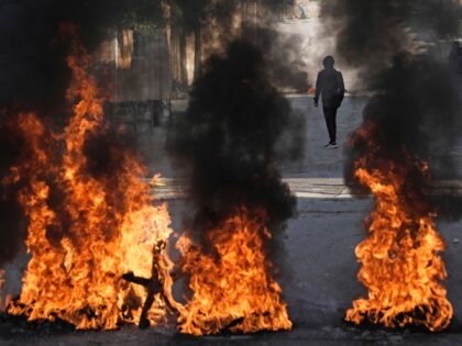 Palestinian demonstrators burn tires in a protest against a deadly Israeli army raid at Ai