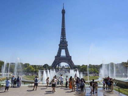 PARIS, FRANCE - AUGUST 9: People cool off near the Fontaine of the Trocadero garden (Fonta