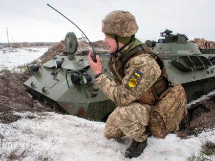 A Ukrainian soldier trains during military drills close to Kharkiv, Ukraine, Thursday, Feb. 10, 2022. Britain's top diplomat has urged Russia to take the path of diplomacy even as thousands of Russian troops engaged in sweeping maneuvers in Belarus as part of a military buildup near Ukraine. (AP Photo/Andrew Marienko)